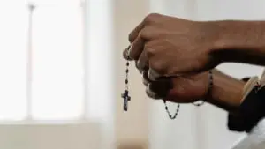 Person Holding Prayer Beads
